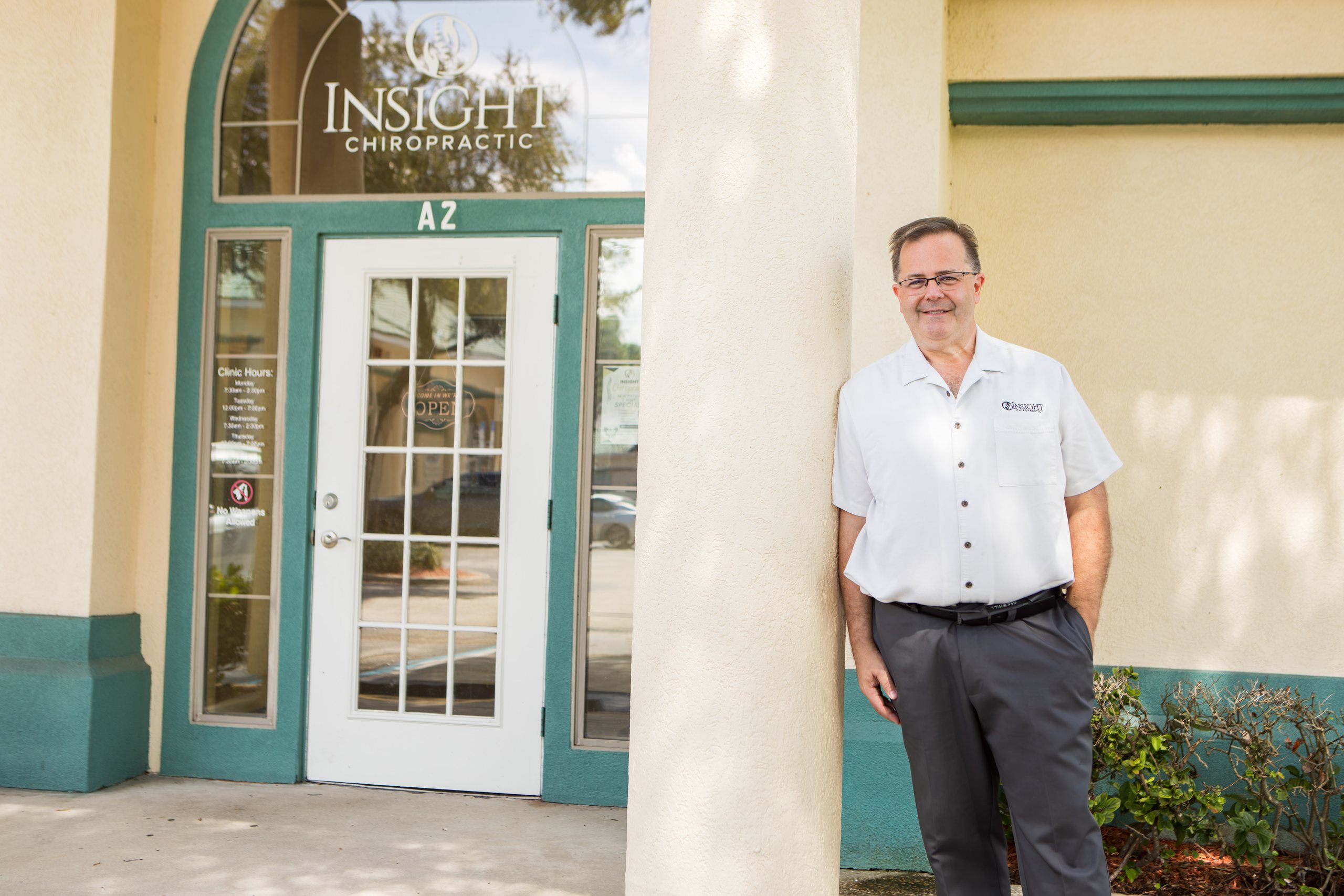 Dr. Michael Cox standing outside the entrance of Insight Chiropractic, Suite A-2, in Ormond Beach