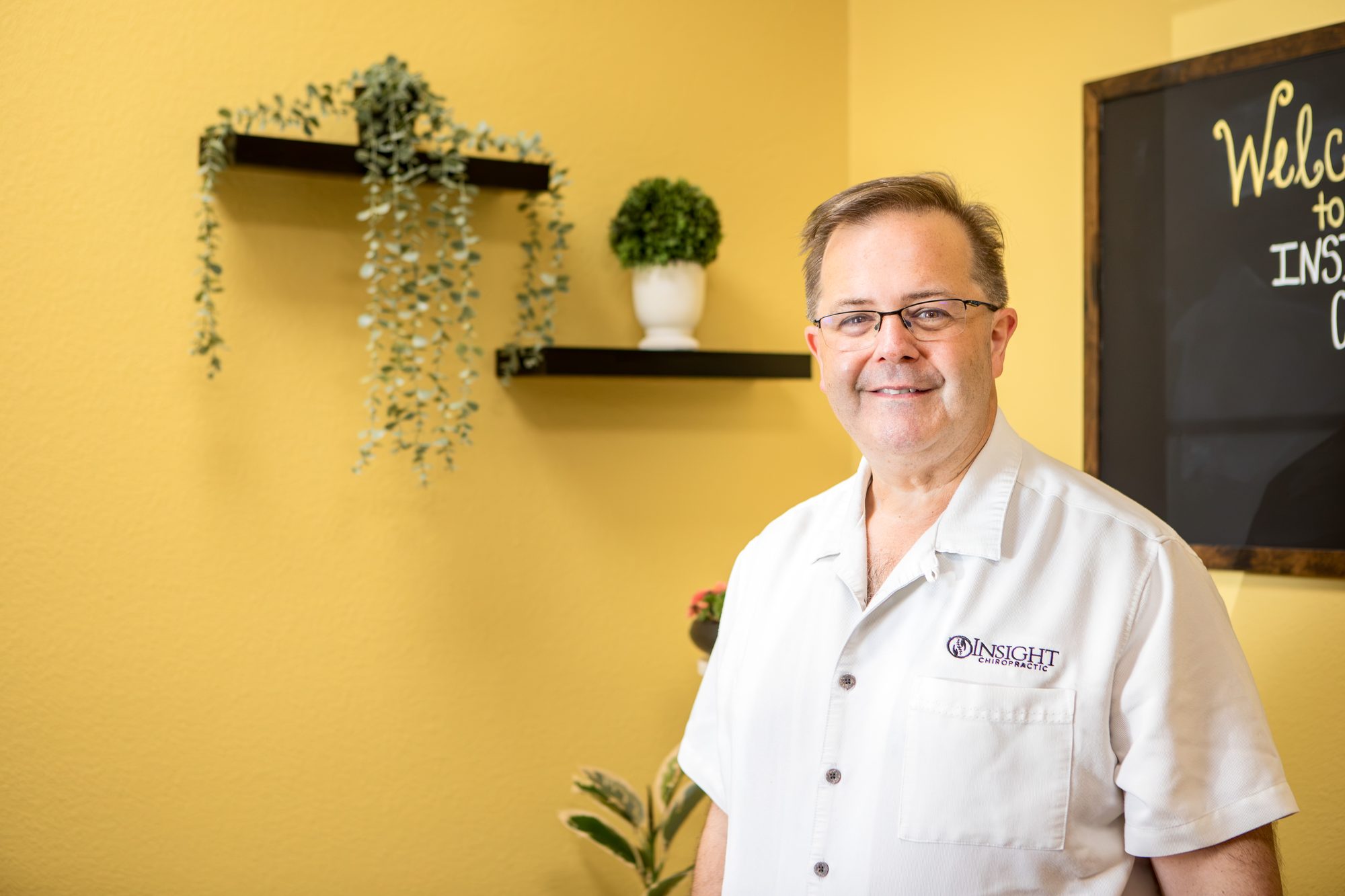 Portrait of Dr. Michael D. Cox standing in his Ormond Beach practice
